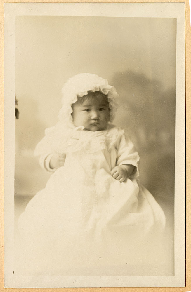Portrait of an infant in a white gown