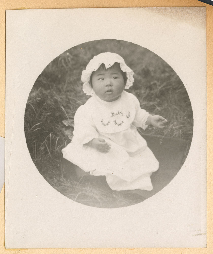 Portrait of infant wearing a bonnet
